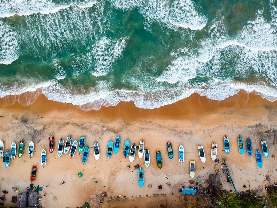 Colourful fishing boats on the sand at Arugam Bay seen from the air